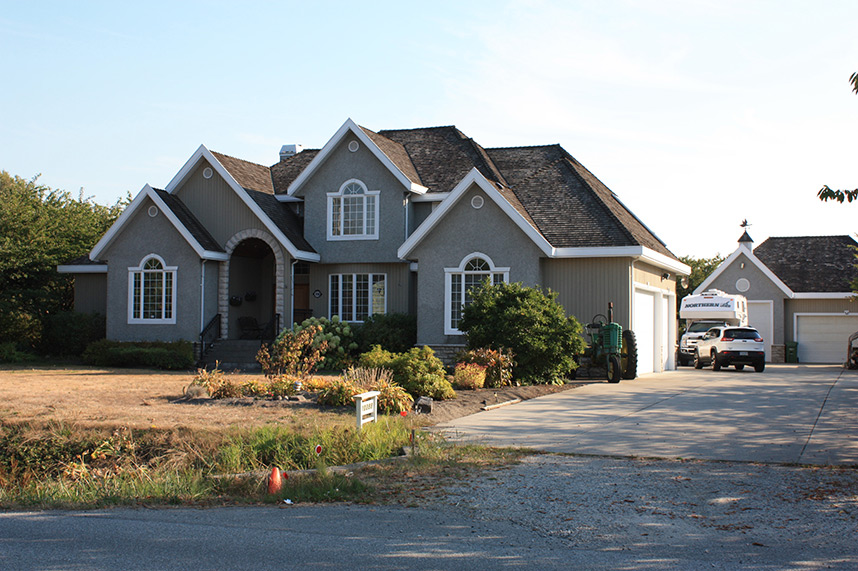 Agricultural land reserve planning large house with empty driveway